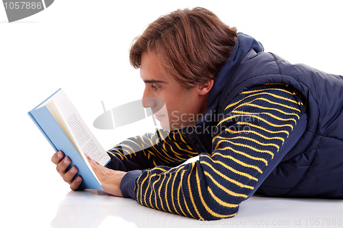 Image of man lying reading a book