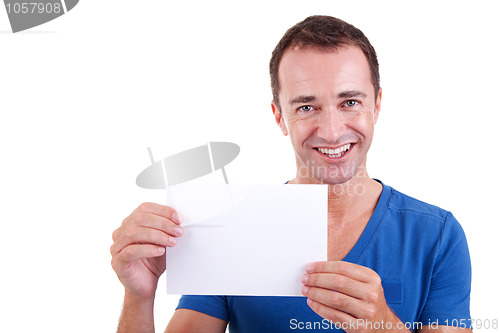 Image of Man holding a white card, smiling and looking to camera