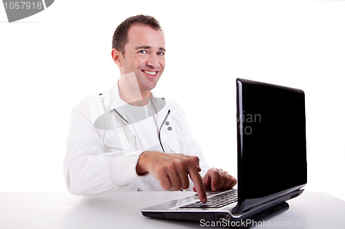 Image of happy man looking to camera, put the finger on computer