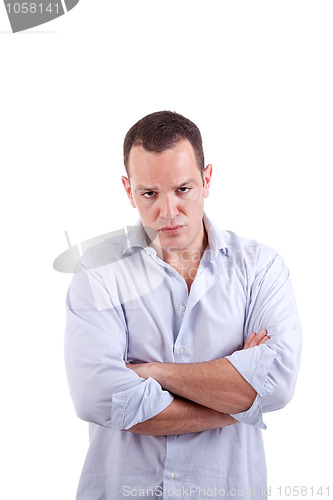 Image of handsome man upset with his arms crossed
