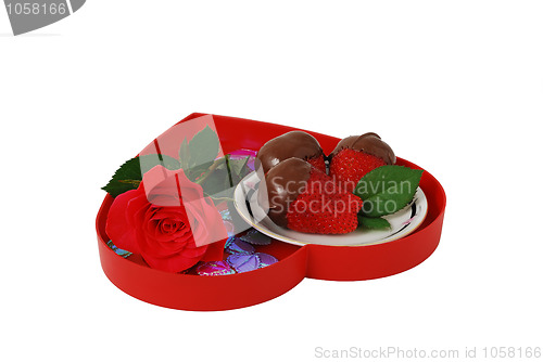 Image of Strawberries in chocolate on red heart shaped tray with rose