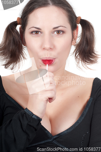 Image of Portrait of pretty woman in black eating candy