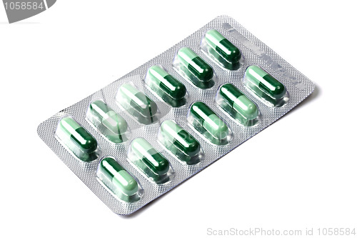 Image of Package of green capsules  isolated on white