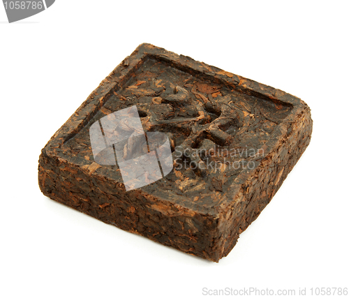 Image of Pressed briquette of green tea with hieroglyphic on white backgr