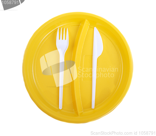 Image of Yellow plastic plate, fork and knife