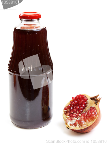 Image of Bottle of juice and ripe piece grenade