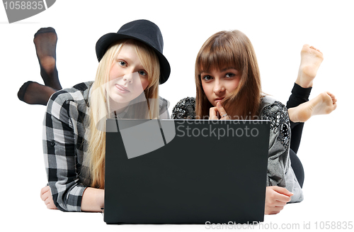 Image of Two girls lies with computer