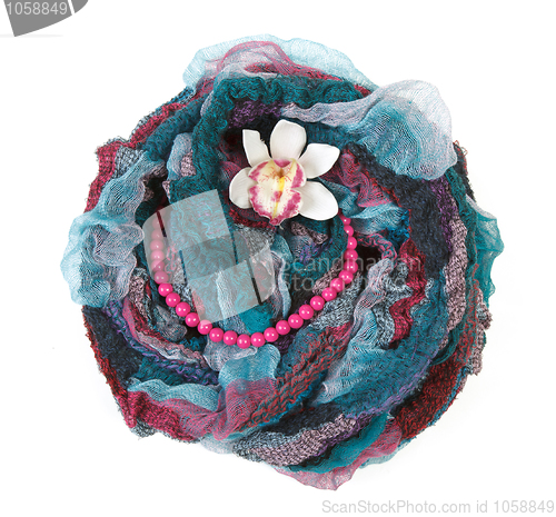 Image of Varicoloured scarf is put with necklace around and flower