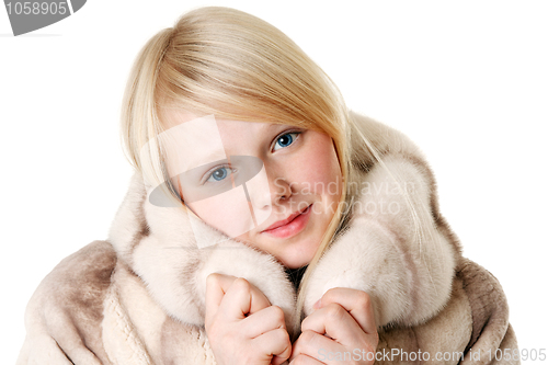 Image of Blonde girl with blue eyes wearing a fur coat