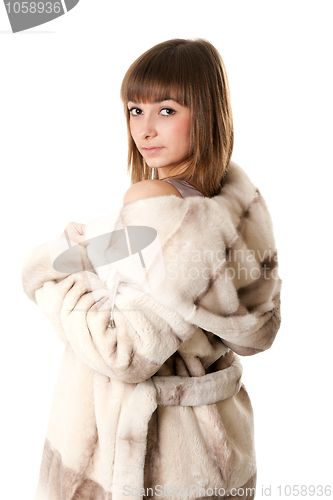 Image of A beautiful young girl in a fur coat