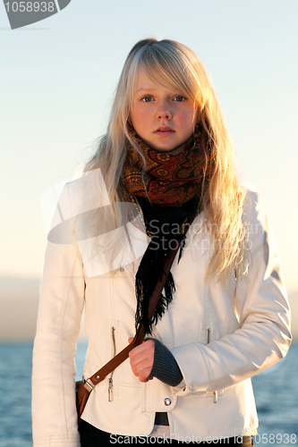 Image of Beautiful blonde on background blue sky