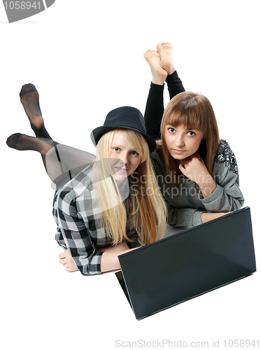 Image of Two girls lies with computer