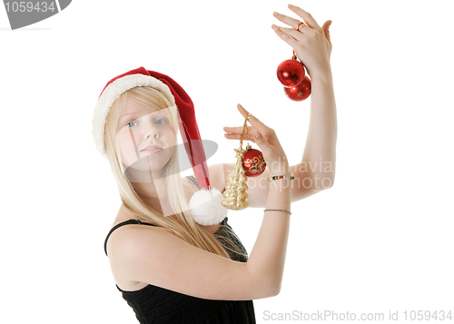 Image of Young beautiful girl in a Santa hat