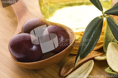 Image of pasta, black olives, oil with fresh branch. food ingredients 