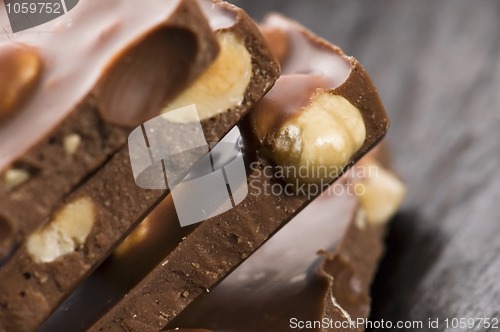 Image of Pile of broken chocolate with nuts 
