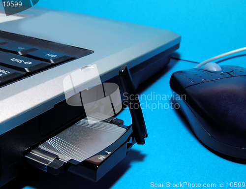 Image of Computer with wireless internet card and mouse over blue background