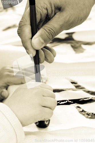 Image of Teacher Helping Student drawing hieroglyph