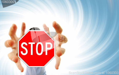 Image of Man grabing a stop sign