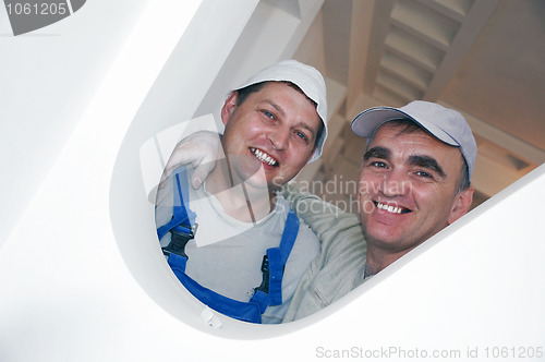 Image of two smiling construction workers