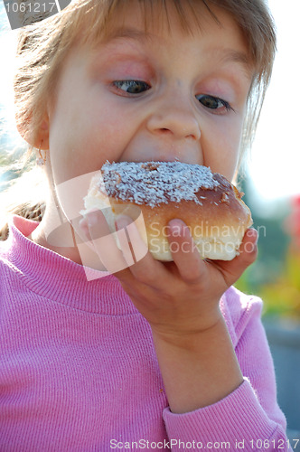 Image of child biting a doughnut