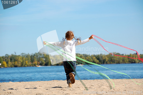 Image of child running and playing with ribbons