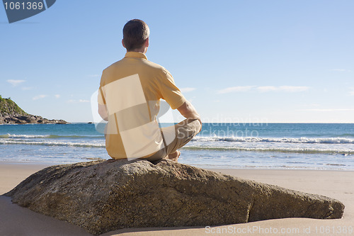 Image of Man meditating on a beach