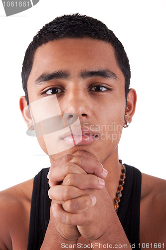 Image of young and handsome latin man, with hand holding the face - thinking