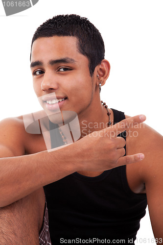 Image of Young latin man with thumbs raised as cool signal