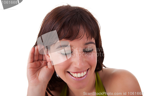 Image of Young woman, listening and smiling, viewing the  gesture of hand behind ear
