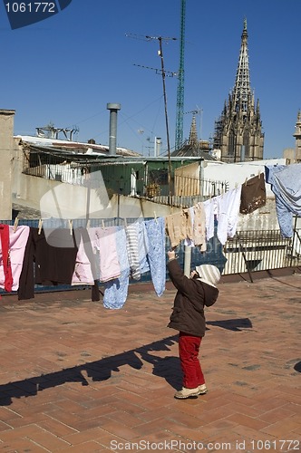 Image of portrait of a sweet girl with the clothesline. urban scene