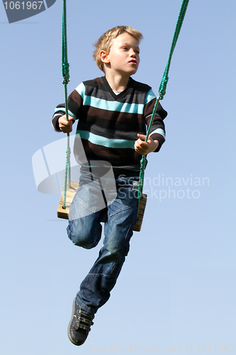Image of Happy child on a swing