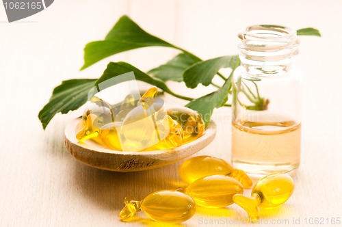 Image of ginko biloba essential oil with fresh leaves - beauty treatment