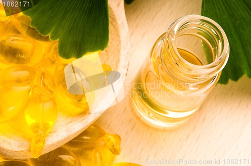 Image of ginko biloba essential oil with fresh leaves - beauty treatment