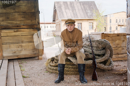 Image of Retro style picture with soldier sitting on the rope