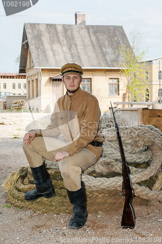 Image of Retro style picture with soldier sitting on the rope