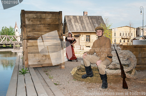 Image of Lady and soldier with  gun in retro style picture