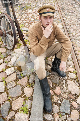 Image of Retro style picture with smoking soldier.