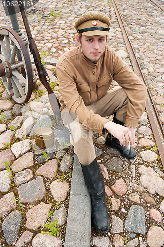 Image of Retro style picture with smoking soldier.