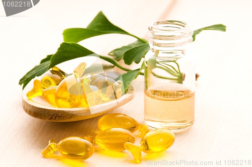 Image of ginko biloba essential oil with fresh leaves - beauty treatment 