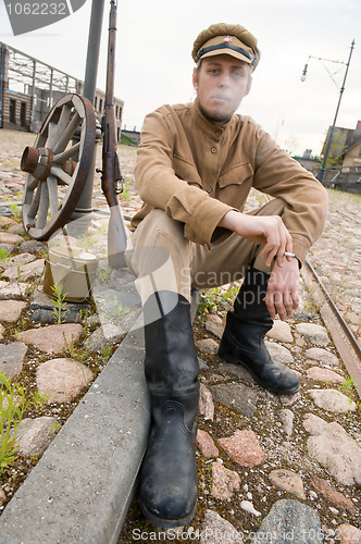 Image of Retro style picture with smoking soldier.