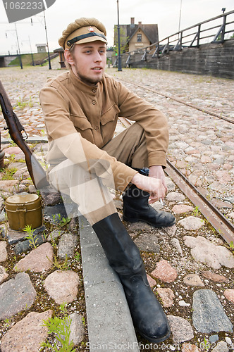 Image of Retro style picture with resting soldier.