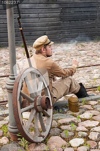 Image of Retro style picture with resting soldier.