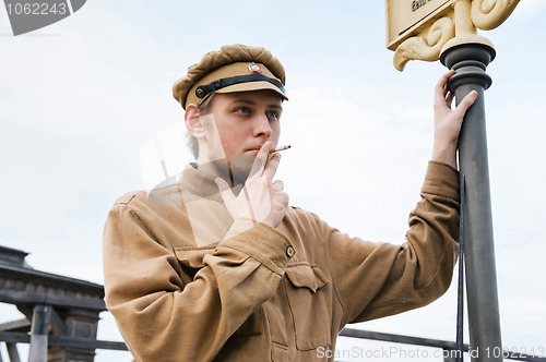 Image of Retro style picture with smoking soldier.