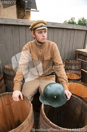 Image of Retro style picture with soldier sitting on the butt