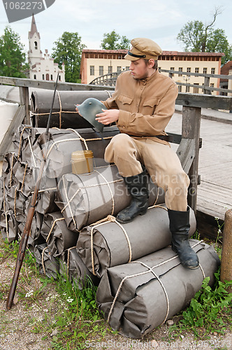 Image of Retro style picture with soldier sitting on the bundles