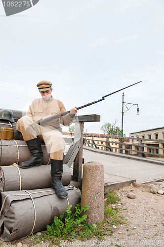 Image of Retro style picture with soldier sitting on the bundles