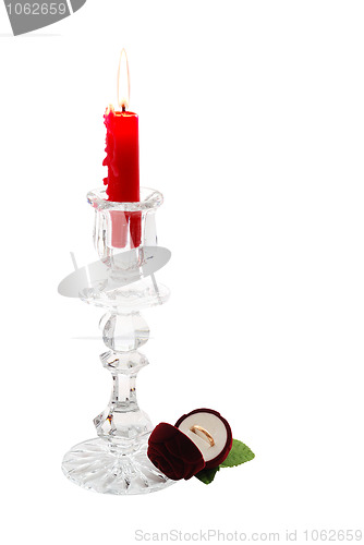 Image of Romantic proposal with candle in glass candlestick and golden ring in rose shaped box