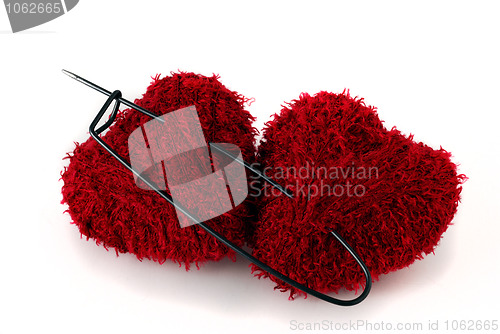 Image of Two heart shaped clews pinned with huge pin