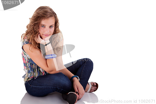 Image of beautiful blonde young woman sitting on floor