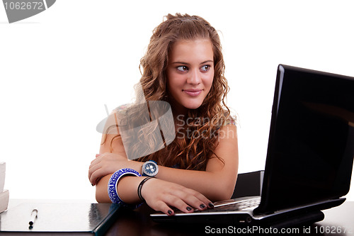 Image of beautiful and happy blonde young woman,looking to computer
